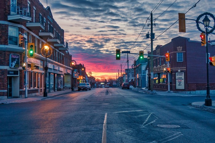 Street scene at sunset with traffic lights and buildings