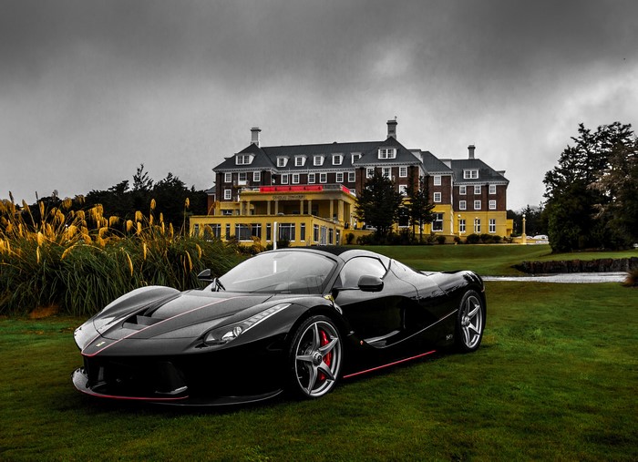Black Ferrari LaFerrari Aperta in front of a mansion