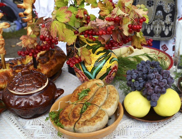 Sausages, Grapes, Apples, and Pastries on a Table