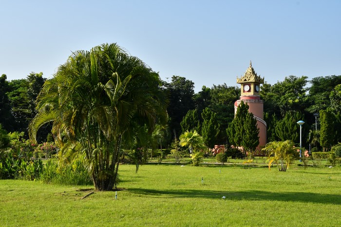 Clock tower in a park with palm trees in Naypyidaw, Myanmar