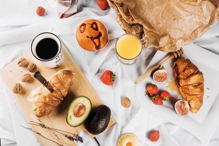 Croissant, Coffee, Avocado, and Breakfast Spread