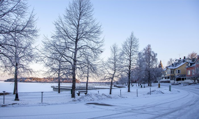Winter scene in Naantali, Finland with snow-covered trees and houses