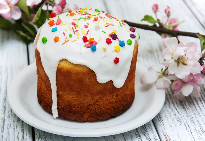 Easter Kulich cake with sprinkles and apple blossoms