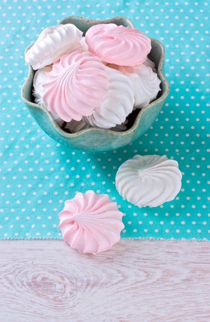 Pink and white meringues in a bowl