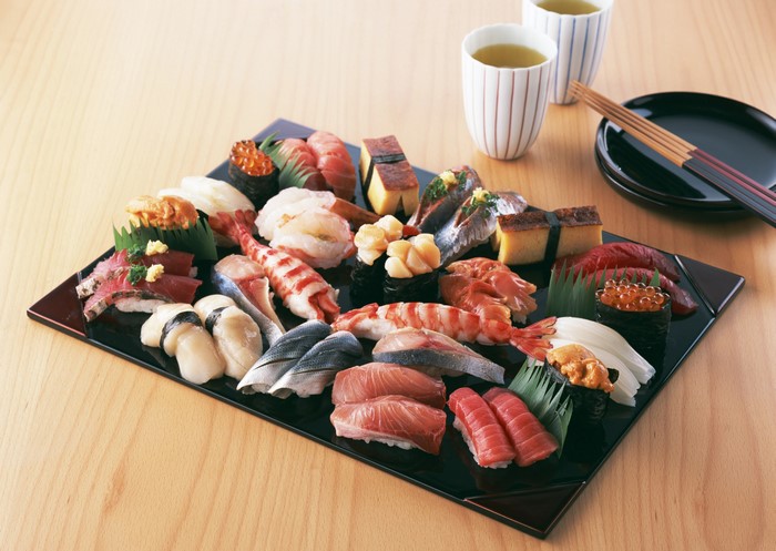 Sushi platter with tea and chopsticks