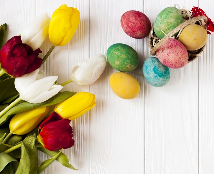 Easter eggs and tulips on a wooden background