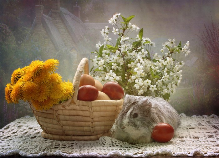 Easter still-life with guinea pig, dandelions, and eggs