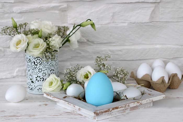 Easter eggs and white flowers in a vase