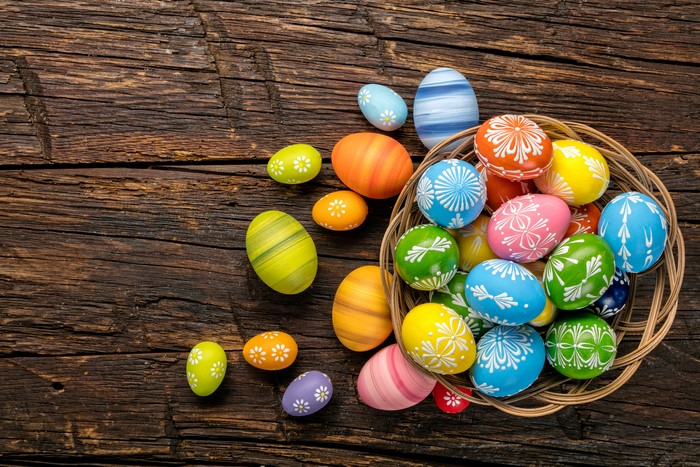Easter Eggs in a Basket on a Wooden Table