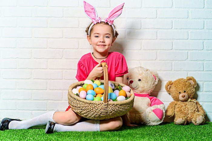 Girl with Easter basket and teddy bears