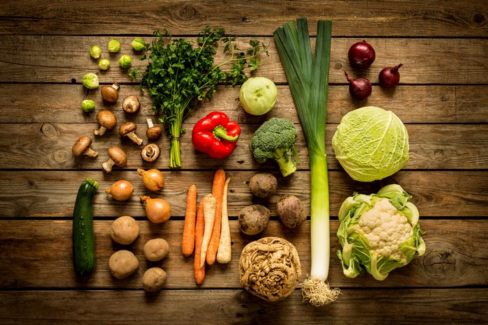 Assortment of fresh vegetables on wooden planks