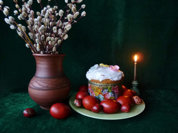 Easter still life with kulich, eggs, pussy willow branches, and candle