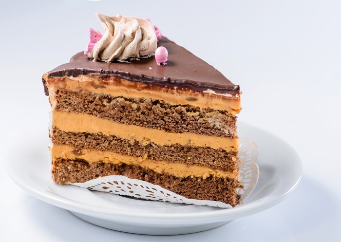 Slice of chocolate cake with caramel filling on a plate