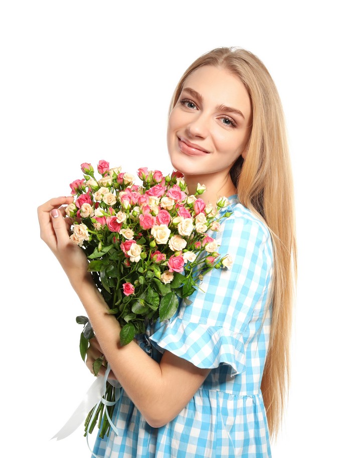 Blonde girl holding a bouquet of roses