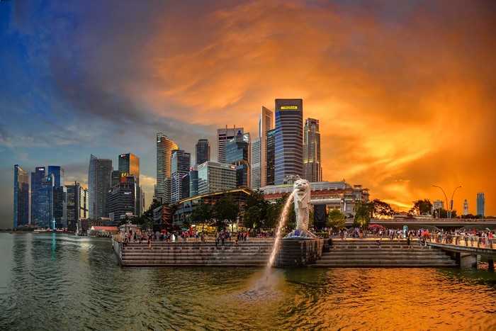 Singapore skyline with Merlion fountain at sunset