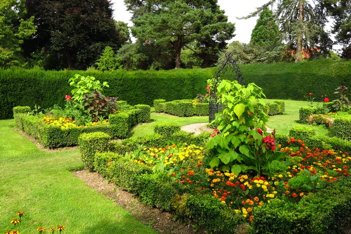 Formal garden with manicured hedges and colorful flowers