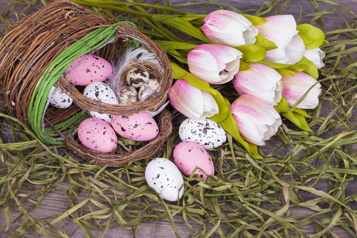 Easter eggs and tulips in a wicker basket