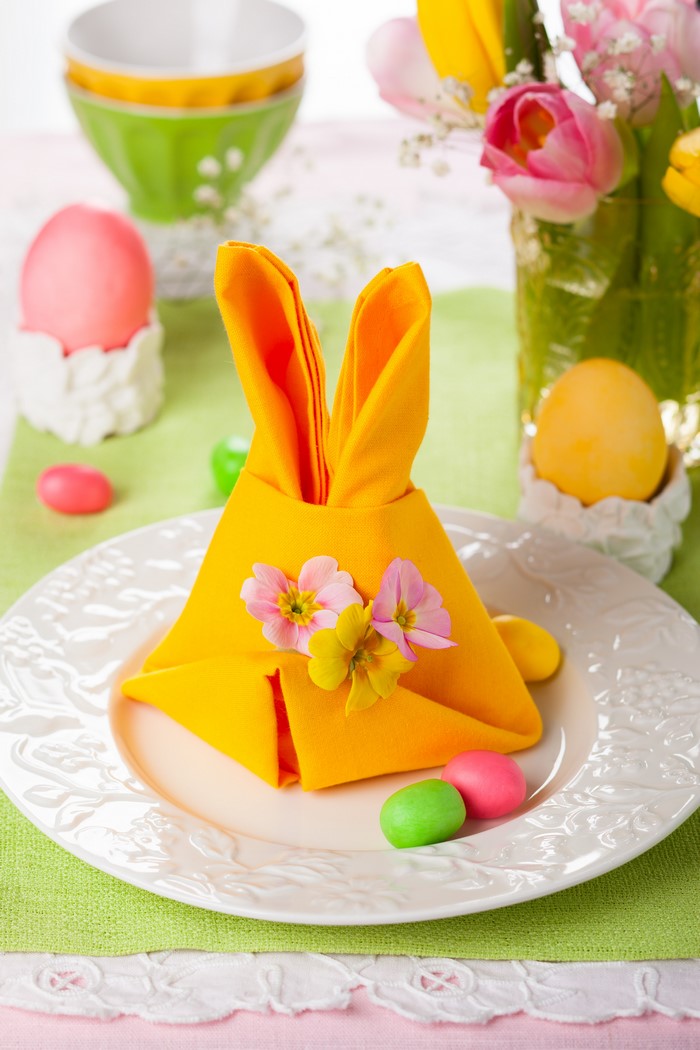 Easter table setting with bunny napkin and eggs