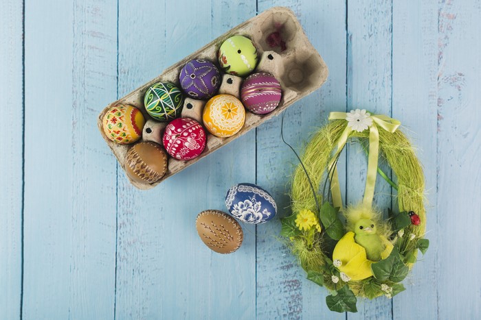 Easter eggs in a carton and a decorative wreath