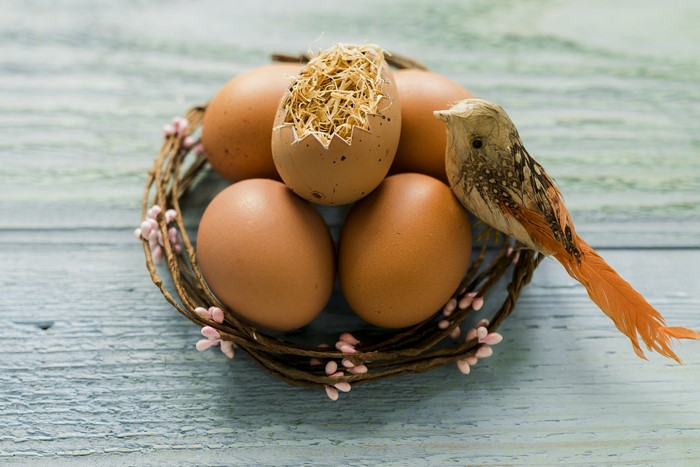 Easter eggs in a nest with a decorative bird