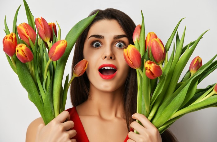 Woman with Surprise Emotion Holding Tulips