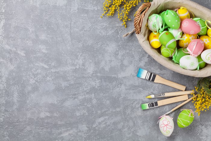 Easter Eggs and Paintbrushes on a Gray Surface