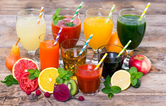 Assortment of Fresh Juices and Fruits on Wooden Planks