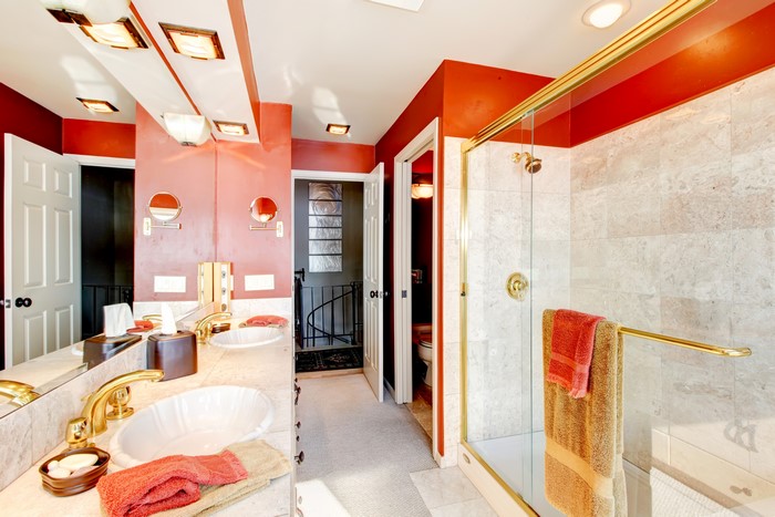 Luxury bathroom with red walls and marble shower