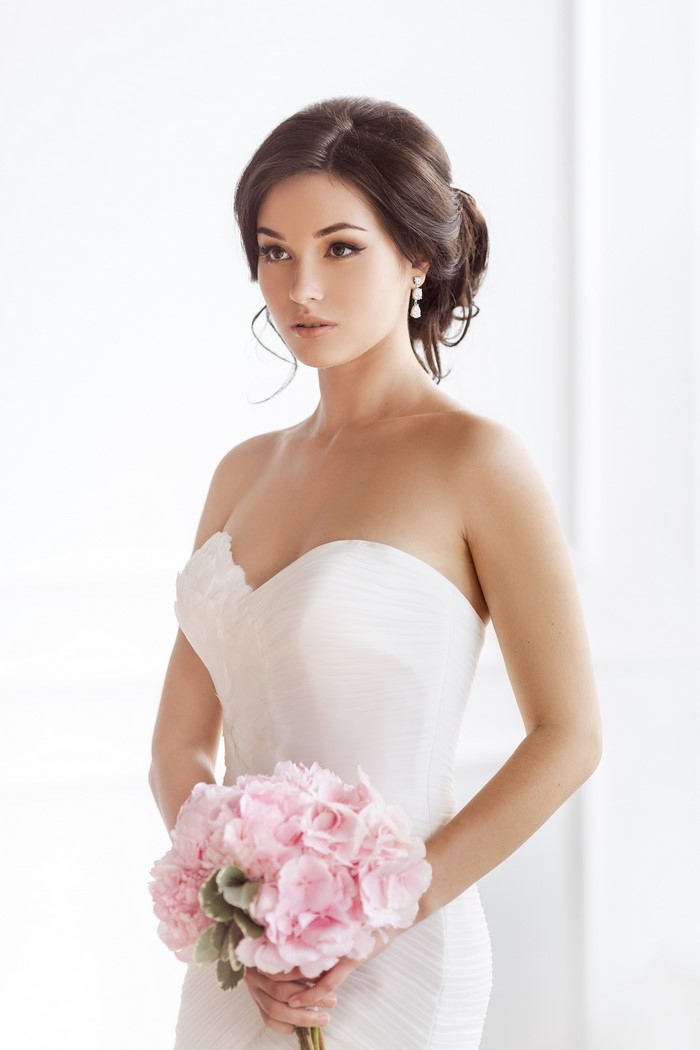 Bride in a white dress holding a pink bouquet