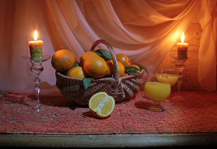 Still-life with oranges, juice, and candles