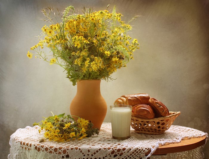 Still-life with wildflowers, milk, and pastries