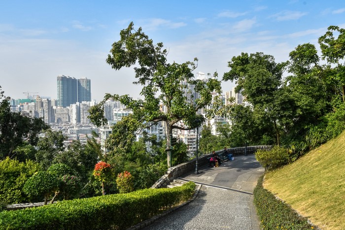 Macao cityscape with trees and park path