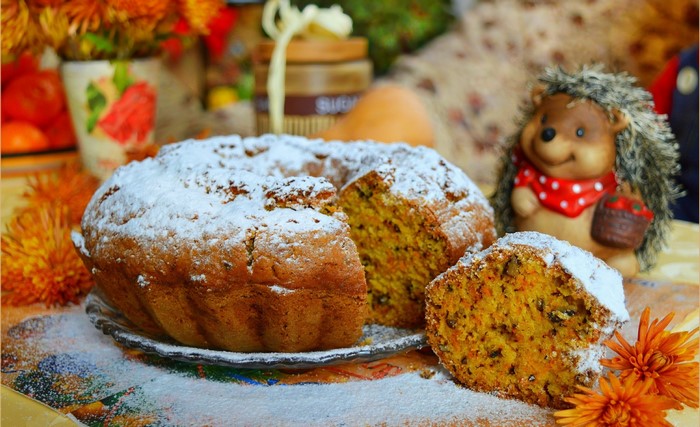 Bundt cake with powdered sugar and a slice cut out
