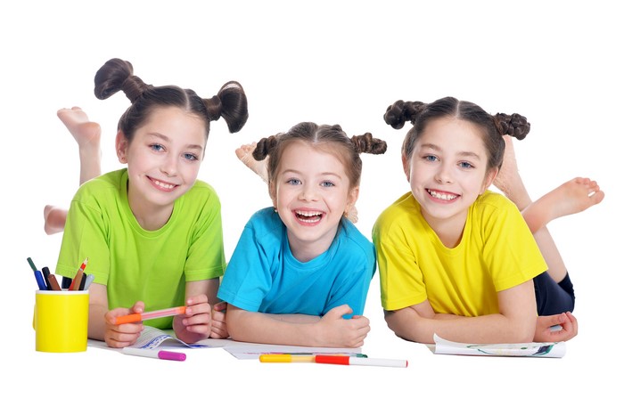 Three little girls with pigtails drawing