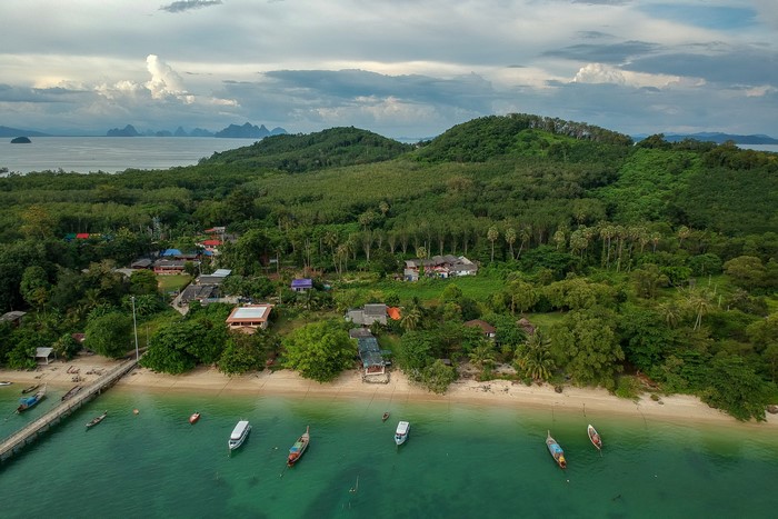 Aerial view of a tropical island village with boats