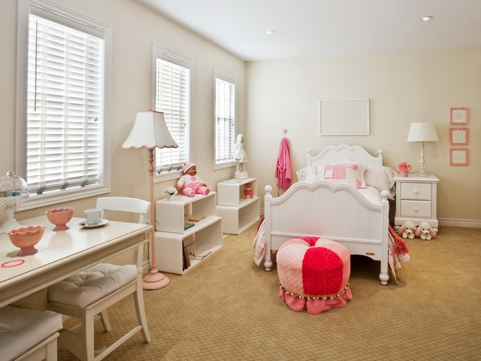 Children's bedroom with white bed and pink accents
