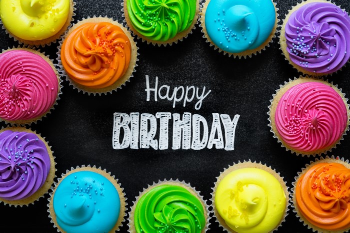 Happy Birthday cupcakes on a dark background