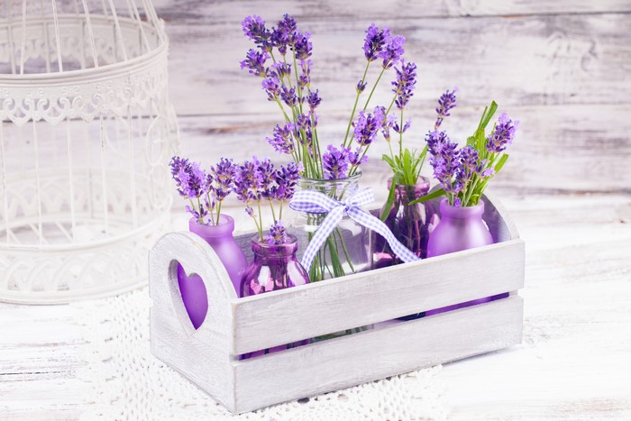 Lavender in purple vases in a wooden crate