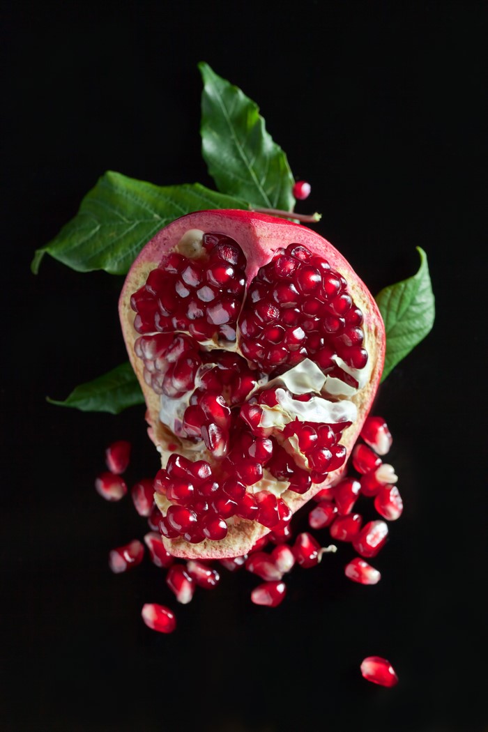 Half Pomegranate with Seeds and Leaves