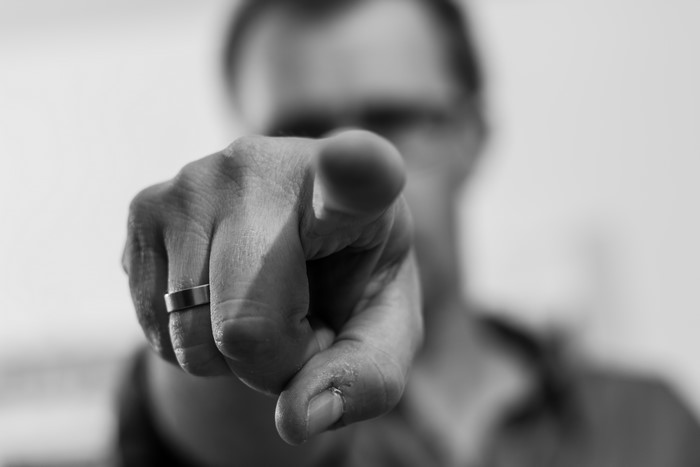 Man pointing finger with ring