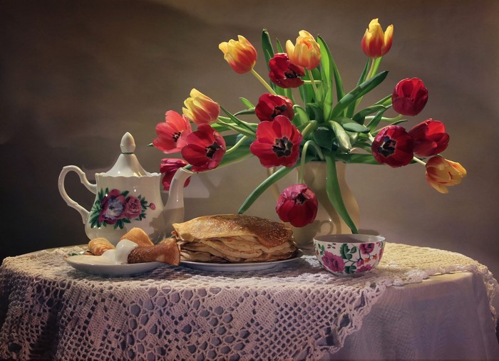 Still-life with tulips, pancakes, and tea set