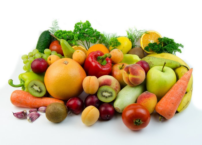 Assortment of fresh fruits and vegetables on a white background