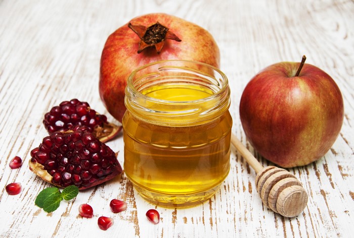 Honey, Apples, and Pomegranates on a Wooden Table