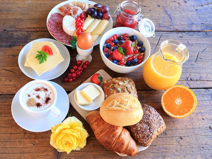 Breakfast spread with coffee, juice, and pastries