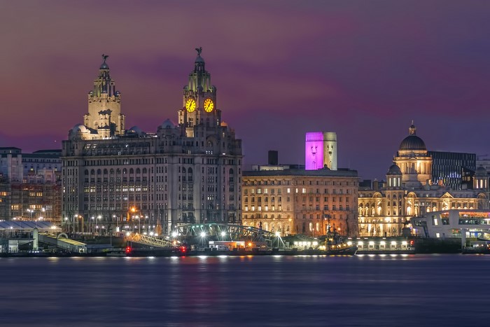 Liverpool skyline at dusk with waterfront buildings and river