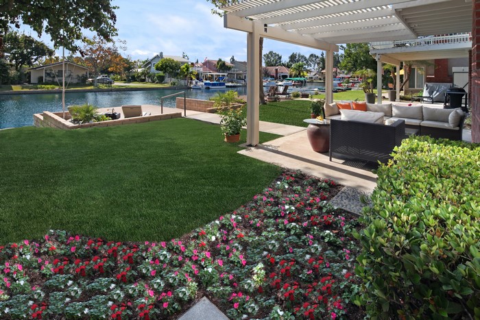 Backyard patio with canal view and flowers