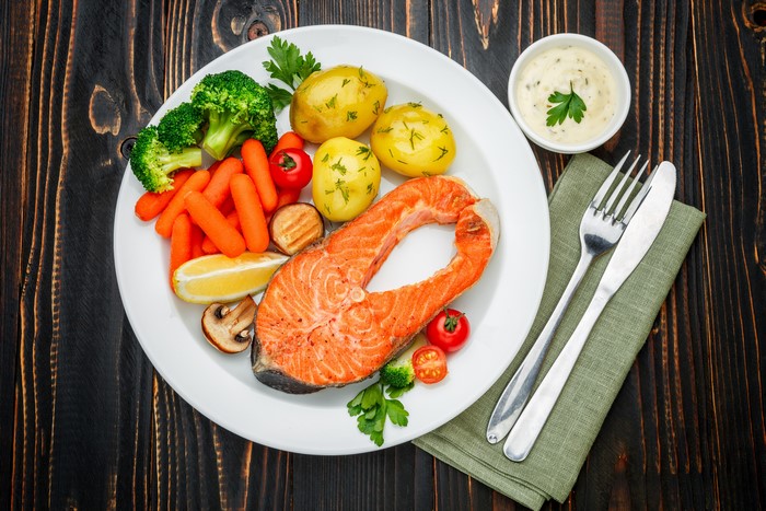 Salmon steak with potatoes, carrots, and broccoli