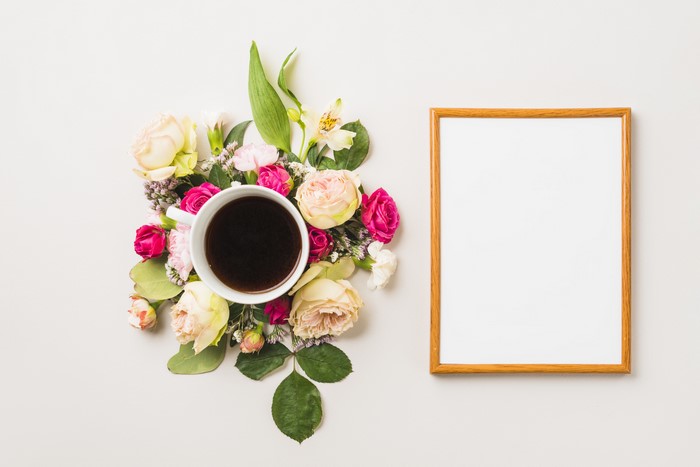Coffee cup with flowers and a picture frame