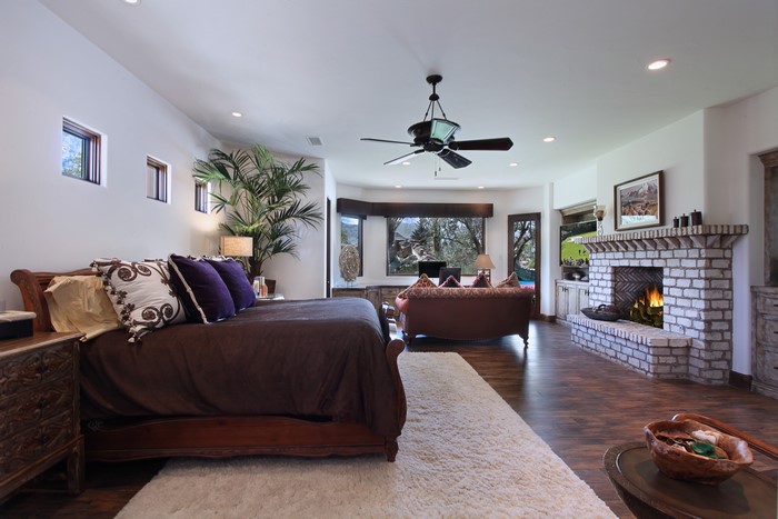 Bedroom with Fireplace and Large Window