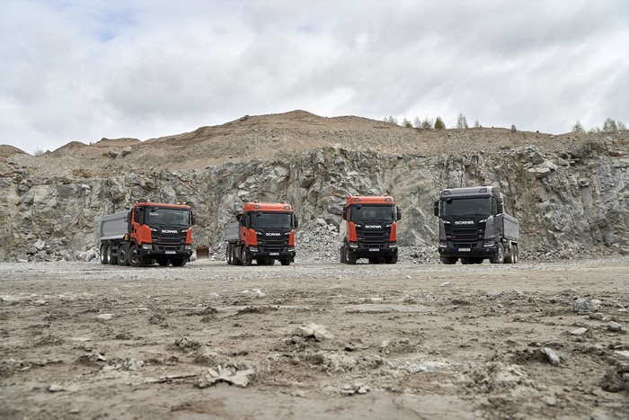 Four Scania trucks in a quarry